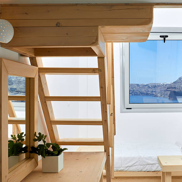 Santorini View Hotel wooden stairs to a single bed bedroom with sea view