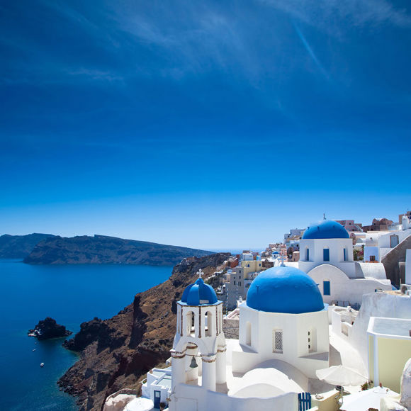 Santorini's vista: The white houses of the villages stand tall above the craters, providing a striking contrast against the azure waters of the Aegean.