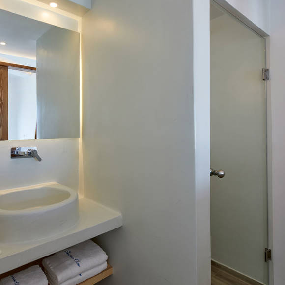 Santorini View Hotel bathroom with white sink, bath amenities and white towels