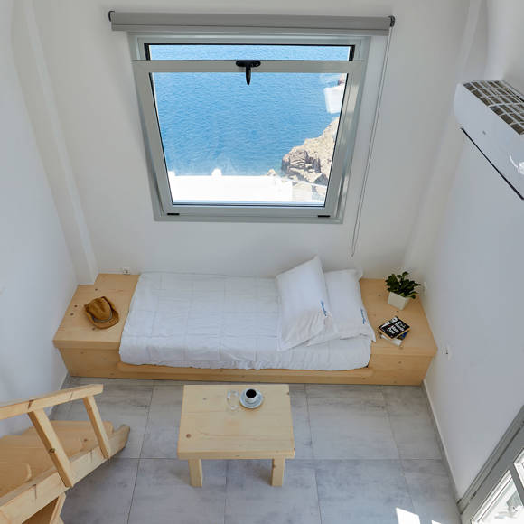 Santorini View Hotel bedroom with single bed and big window with sea view