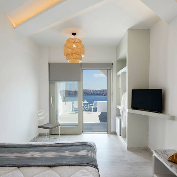 Santorini View Hotel bedroom with double bed and tv, with balcony with aegean sea view