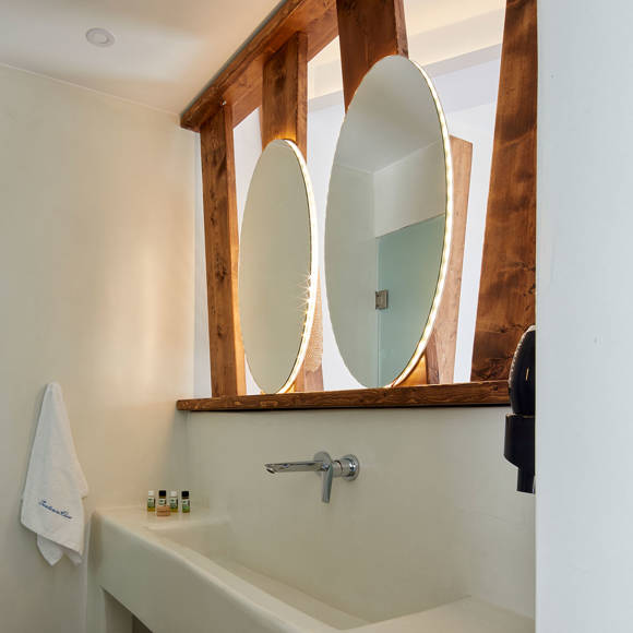 Santorini View Hotel bathroom with two mirrors and wooden decoration