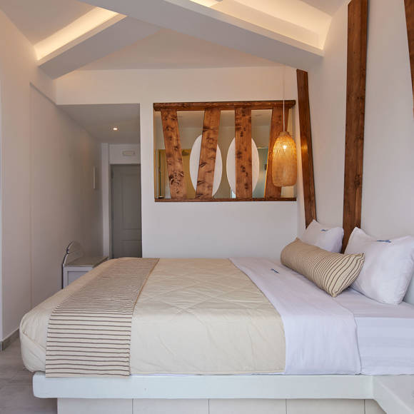 Santorini View Hotel bedroom with king size bed, tv, wooden decoration and bamboo lights