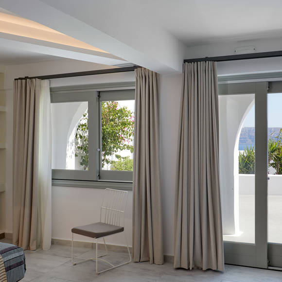 Santorini View Hotel Suite room with gray frames and patio with sea view