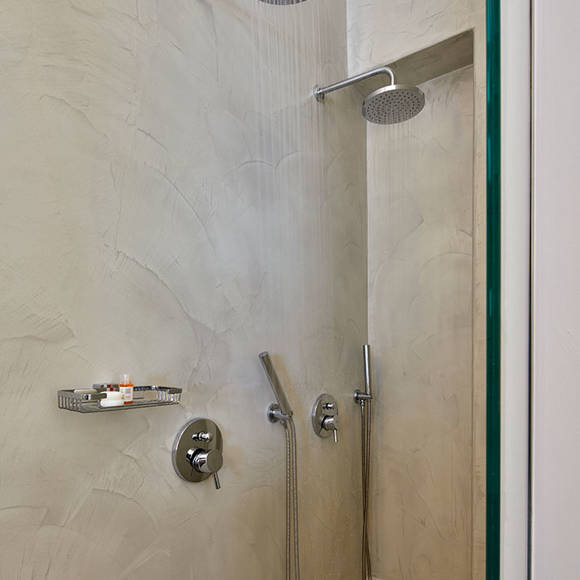 Santorini View Hotel bathroom with shower with two taps and bath amenities